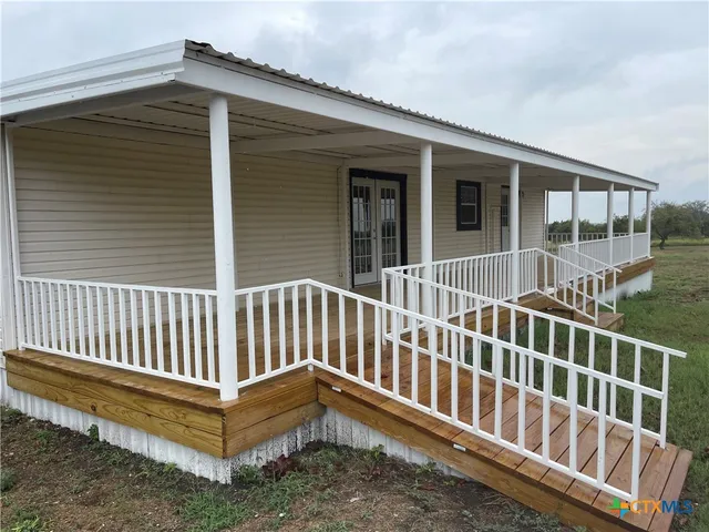 a view of a house with wooden deck