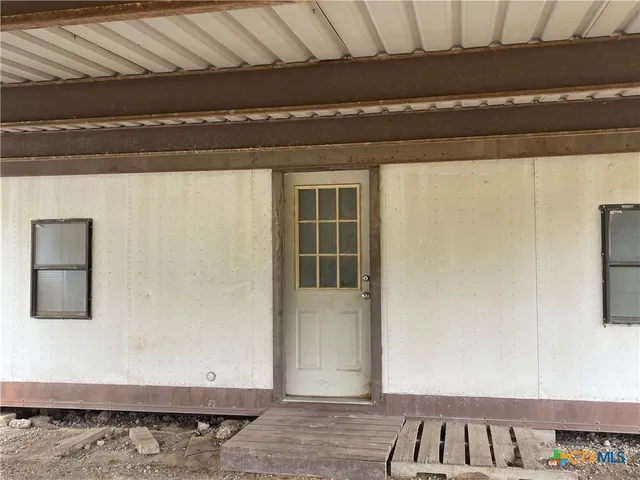a view of a hallway with windows