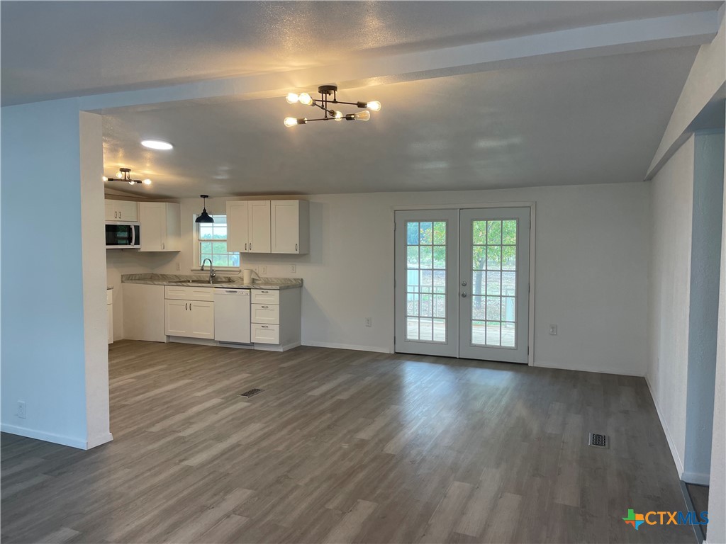 60 County Road 304 Goldthwaite, TX 76844 - Photo 6 of 23 a view of a kitchen with a sink wooden cabinets and a window