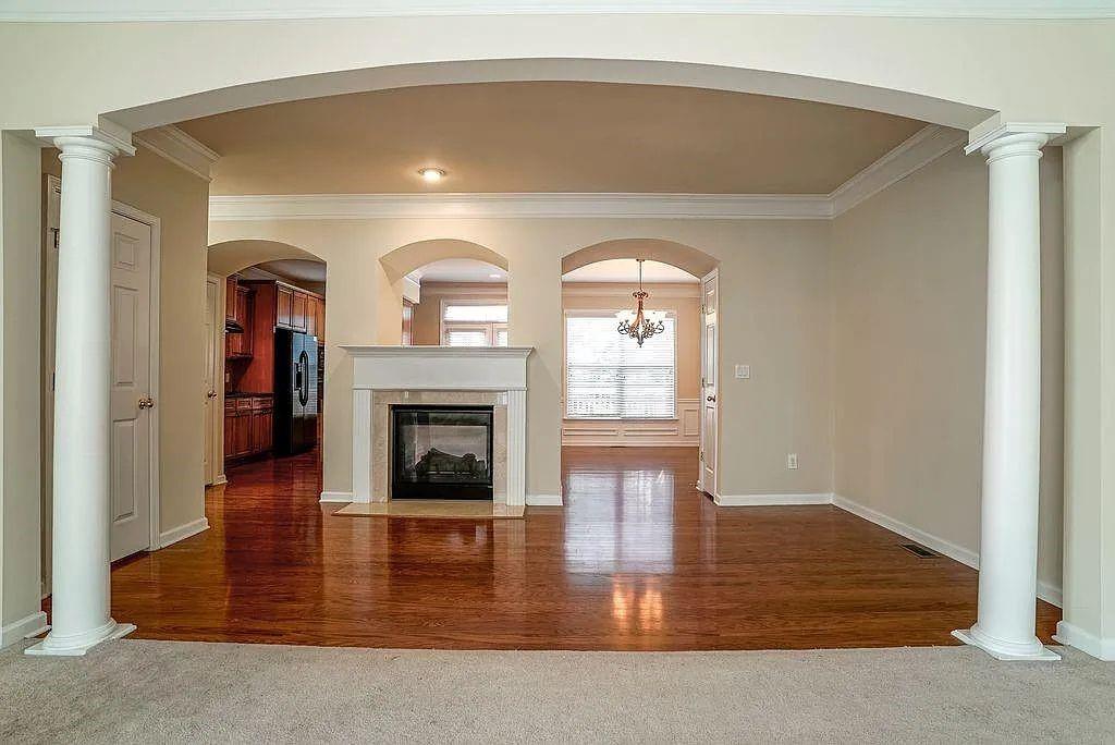 6120 Joybrook Road Duluth, GA 30097 - Photo 6 of 30 a living room with fireplace and a wooden floor