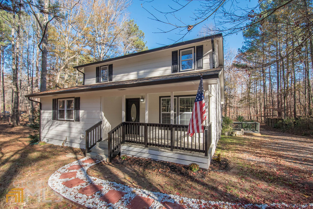 13 Tanglewood Road Newnan, GA 30265 - Photo 1 of 1 a view of a house with a large window and wooden fence