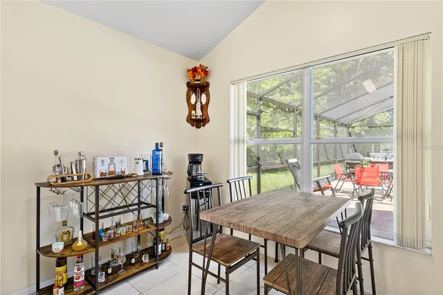a kitchen with refrigerator and chairs