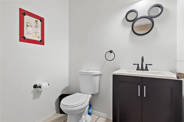 a bedroom with a bed a mirror and a window