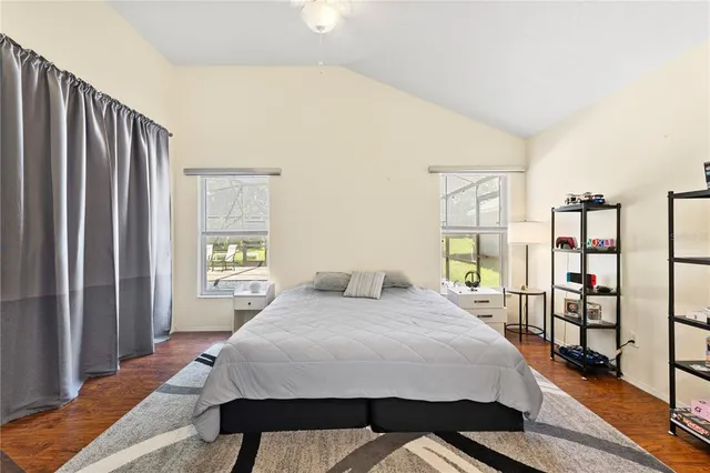 a bedroom with a bed and a large mirror on the dresser