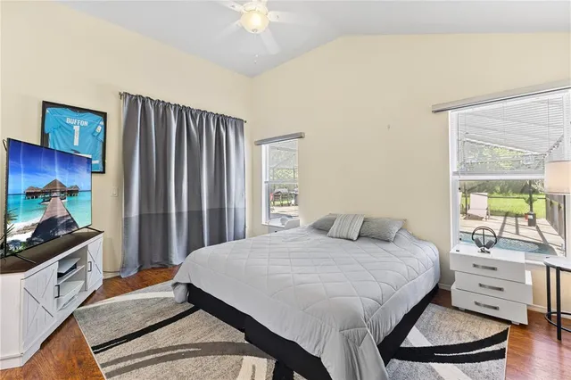 a bedroom with a bed and a flat screen tv