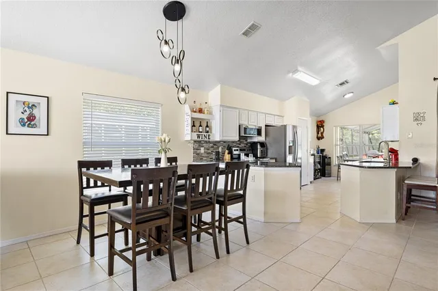 a view of a dining room and livingroom with furniture window and wooden floor