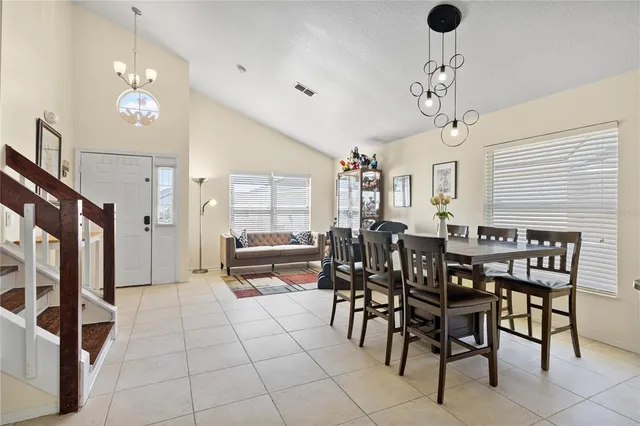 a view of a dining room with furniture and chandelier