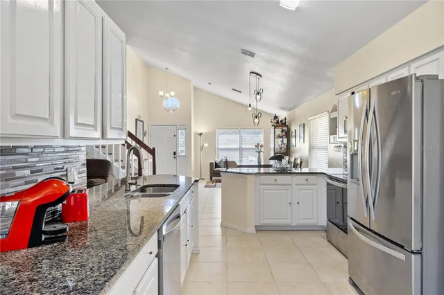 a kitchen with stainless steel appliances a stove sink microwave and cabinets