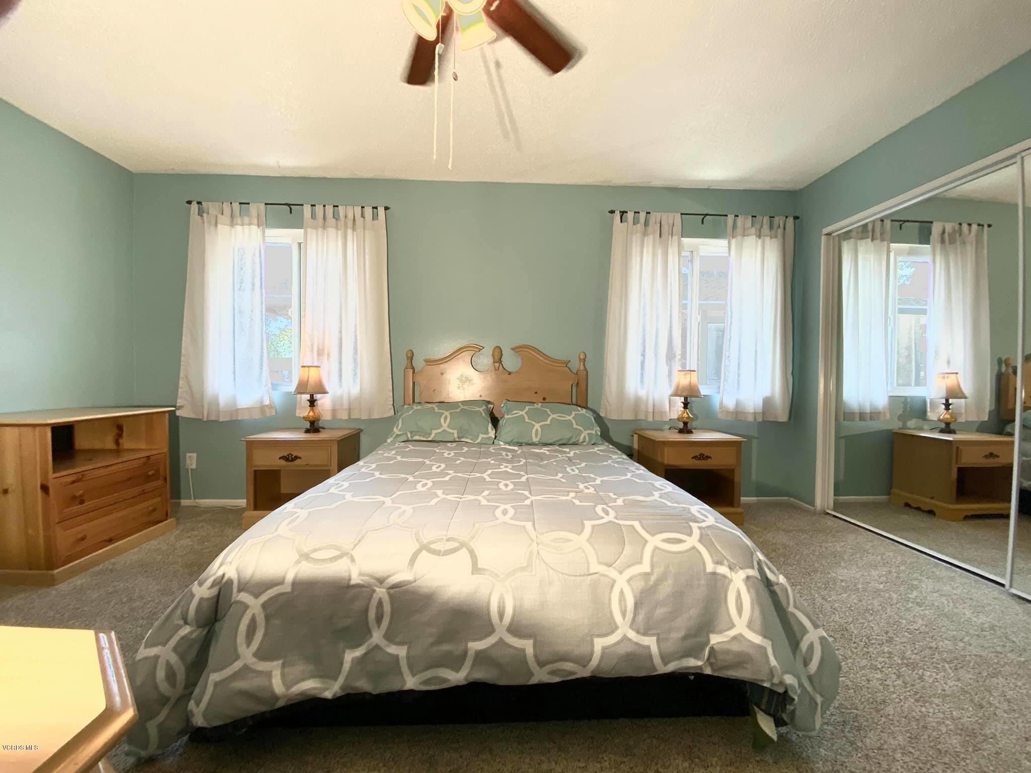 527 Spring Road, Unit 18 Moorpark, CA 93021 - Photo 4 of 6 a bedroom with a bed and a view of walk in closet