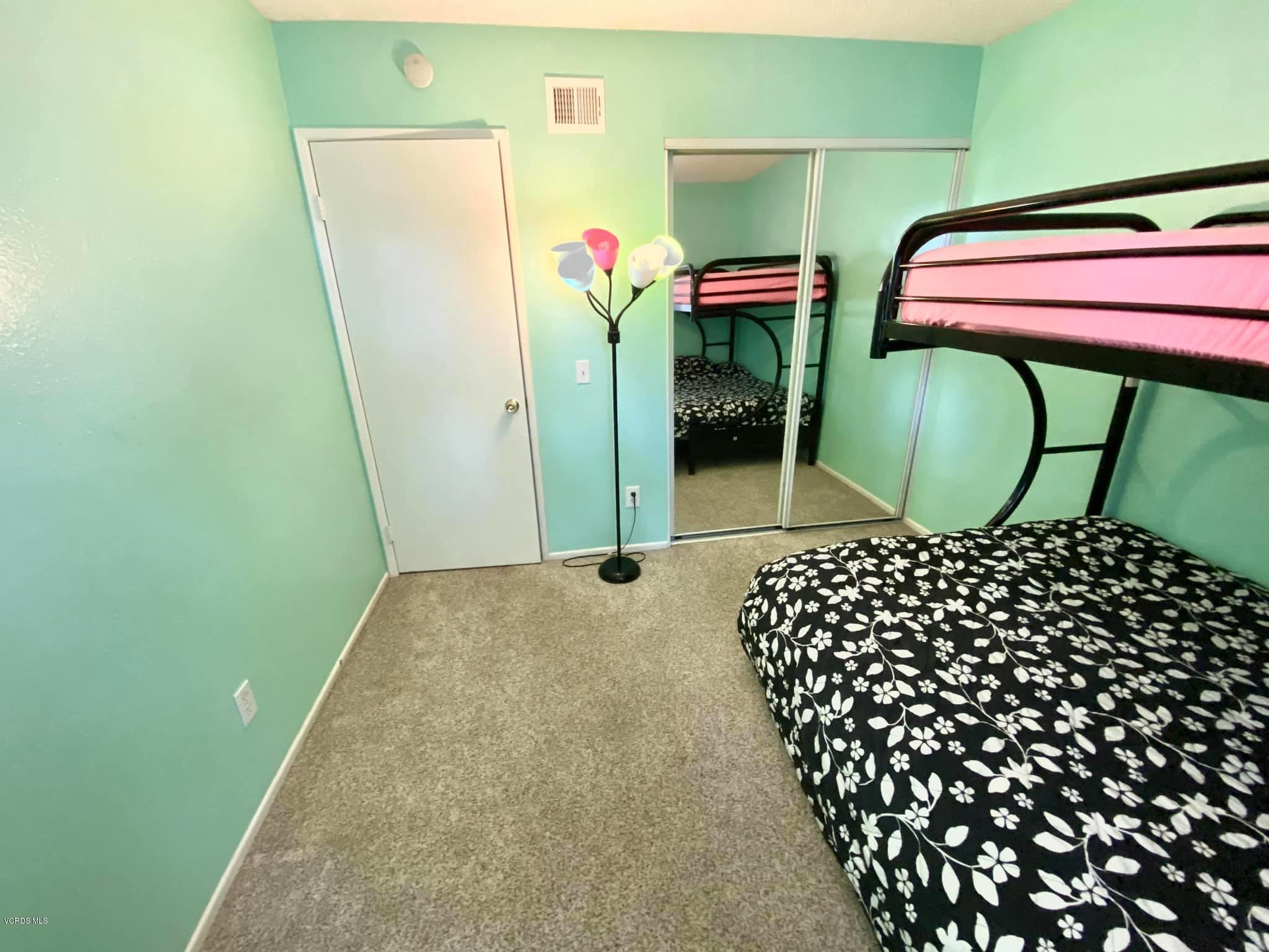 527 Spring Road, Unit 18 Moorpark, CA 93021 - Photo 6 of 6 a bedroom with a bed and a table