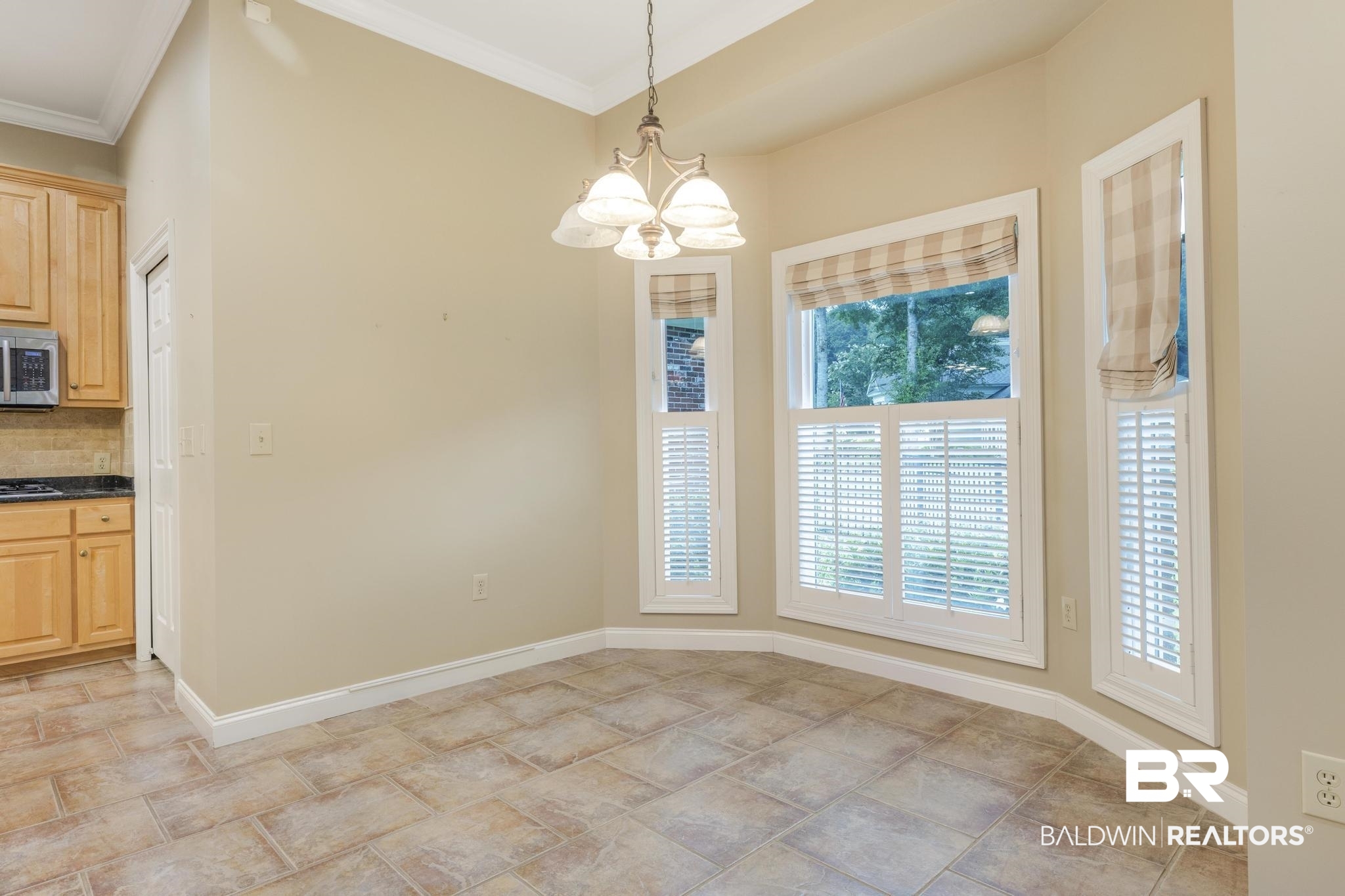 13612 Rue Royal Lane Silverhill, AL 36576 - Photo 17 of 65 Unfurnished dining area featuring a chandelier and crown molding