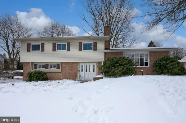 a view of house with a yard covered in snow