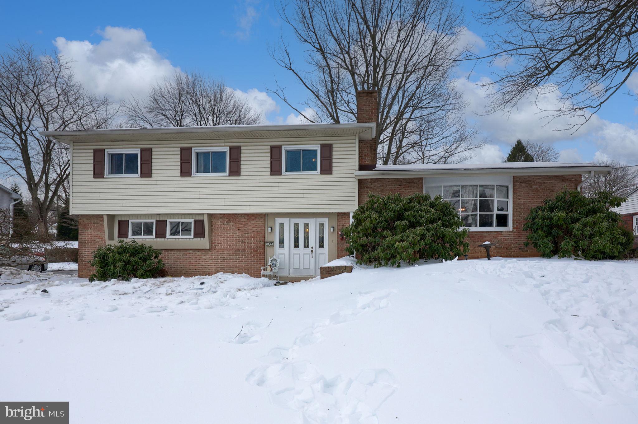 a view of house with a yard covered in snow