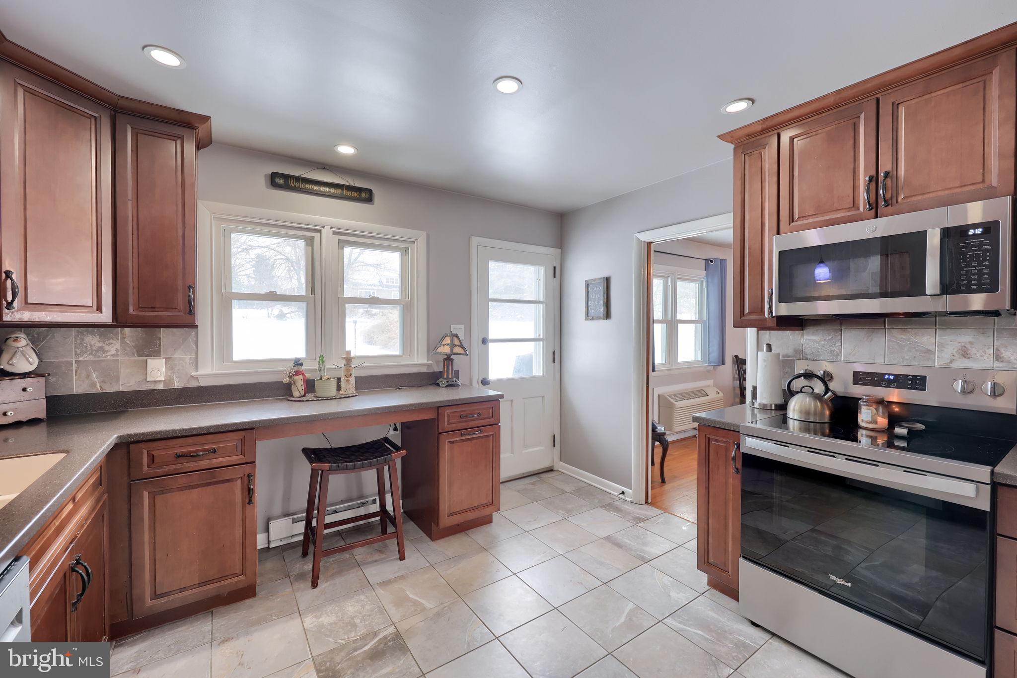 340 Primrose Avenue Lancaster, PA 17601 - Photo 15 of 47 a kitchen with stainless steel appliances granite countertop wooden cabinets a stove a sink and a microwave