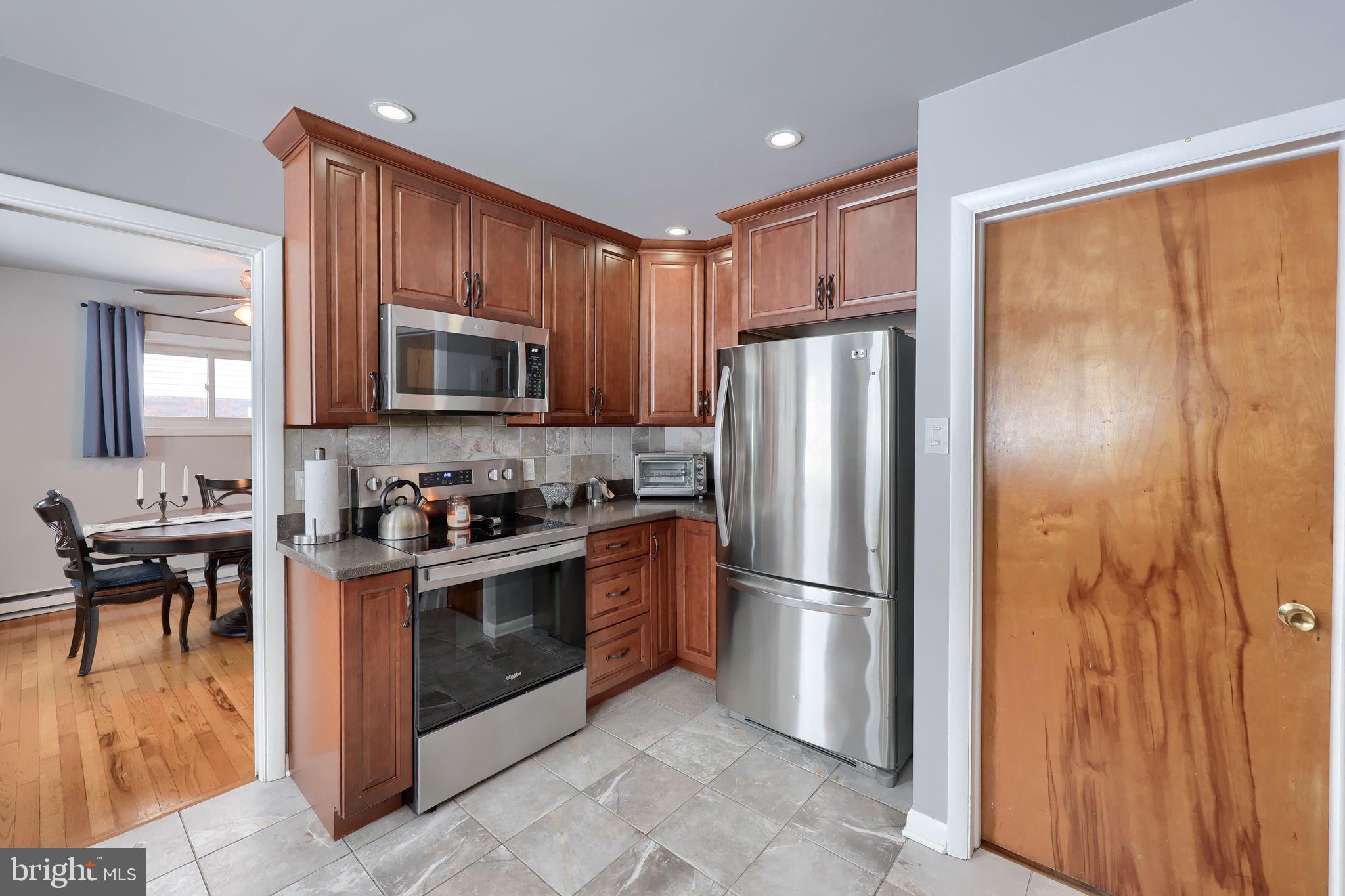 340 Primrose Avenue Lancaster, PA 17601 - Photo 19 of 47 a kitchen with stainless steel appliances granite countertop a refrigerator stove and microwave
