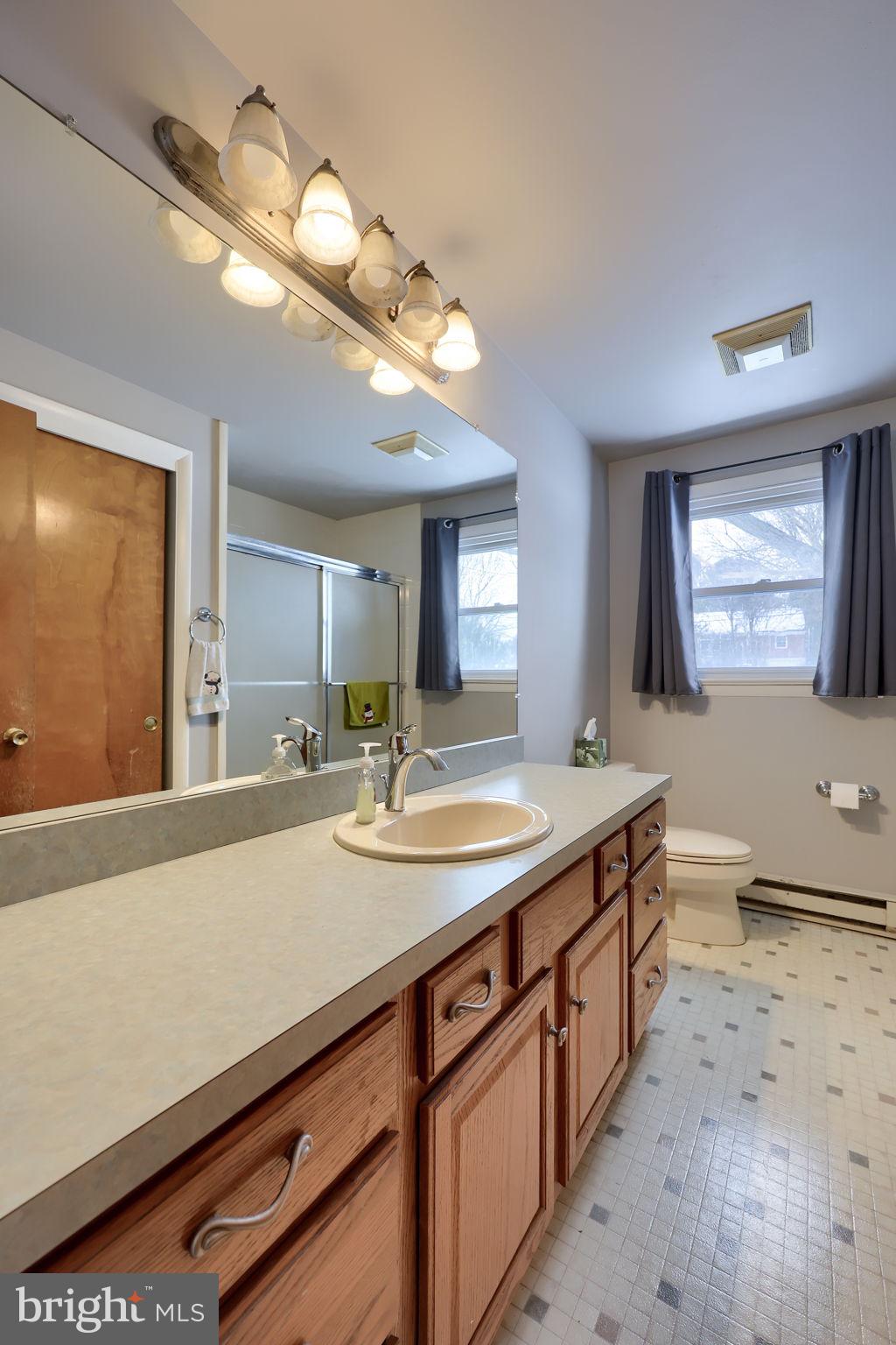 340 Primrose Avenue Lancaster, PA 17601 - Photo 23 of 47 a bathroom with a granite countertop sink a large mirror and vanity