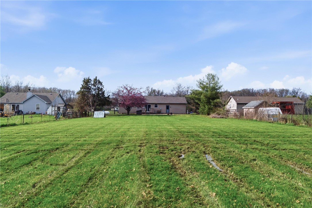 8747 Waynes Way Blanchester, OH 45107 - Photo 37 of 40 Expansive green yard with multiple homes offers a private and serene outdoor experience.