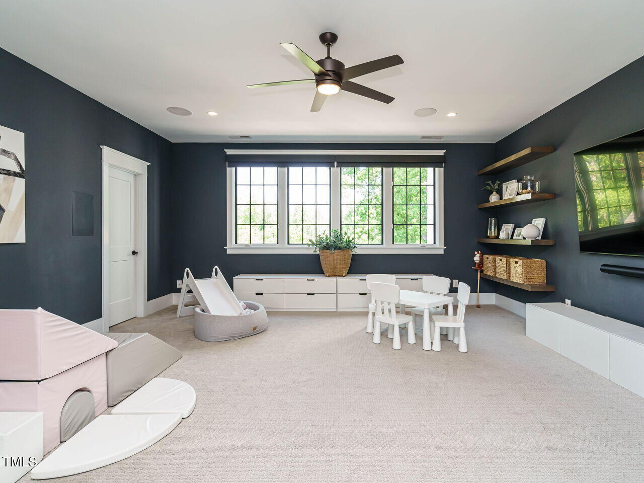 602 Shelley Road Raleigh, NC 27609 - Photo 54 of 64 a living room with furniture a fireplace and a flat screen tv