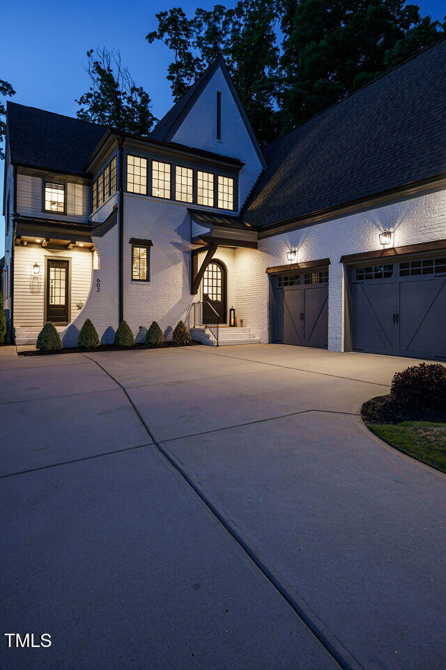 602 Shelley Road Raleigh, NC 27609 - Photo 8 of 64 a front view of a house with a yard and garage