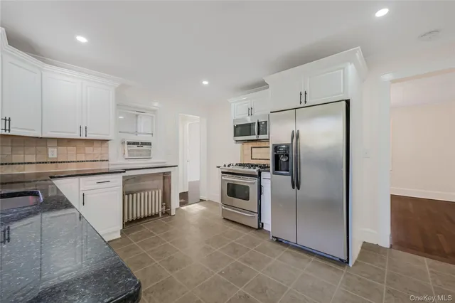 a kitchen with a refrigerator sink and stainless steel appliances