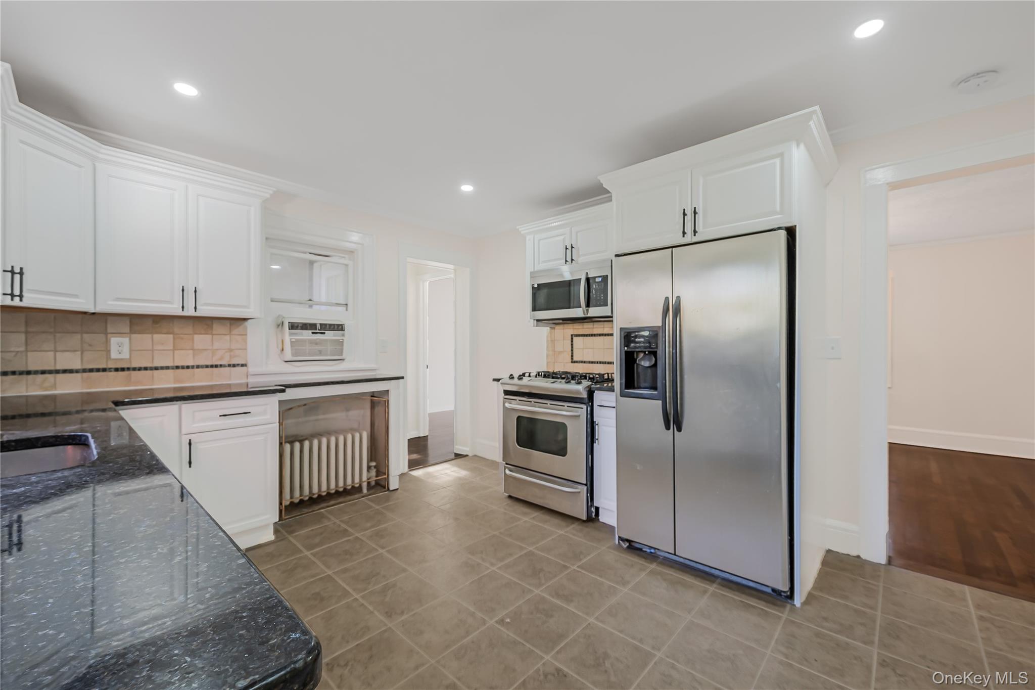 39 Hillcrest Road Hartsdale, NY 10530 - Photo 14 of 42 a kitchen with a refrigerator sink and stainless steel appliances
