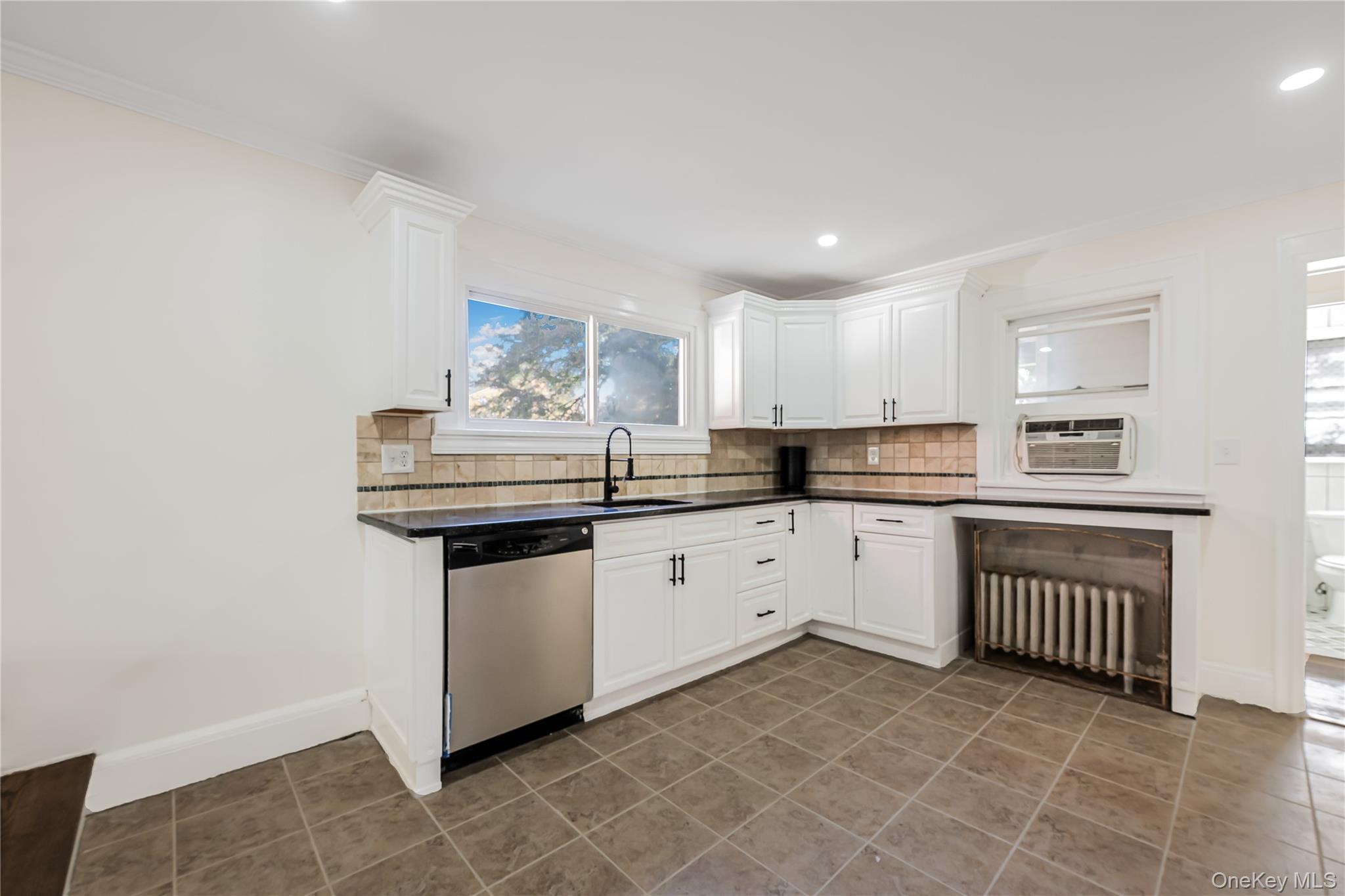 39 Hillcrest Road Hartsdale, NY 10530 - Photo 15 of 42 a kitchen with stainless steel appliances granite countertop a sink and cabinets