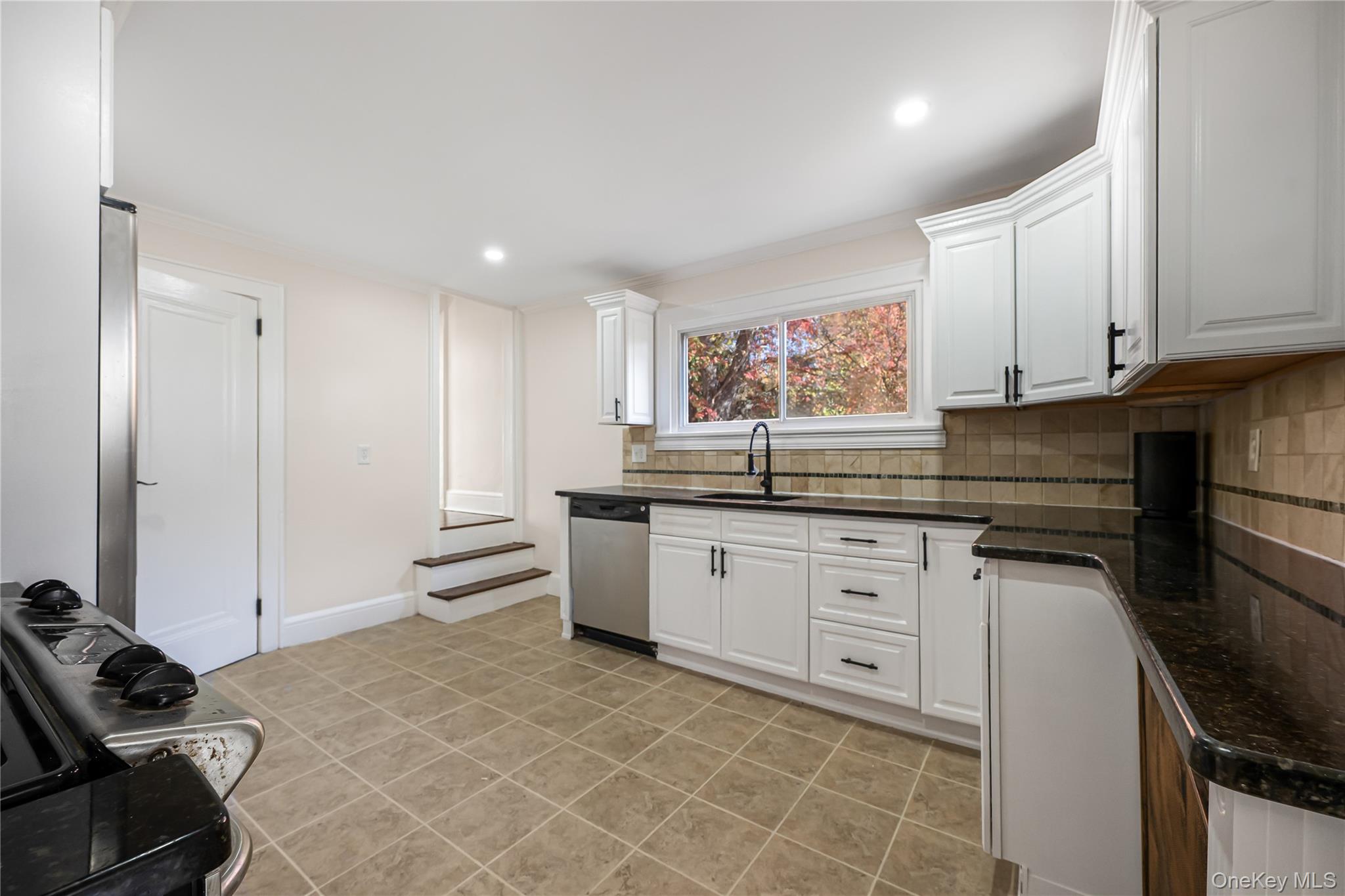 39 Hillcrest Road Hartsdale, NY 10530 - Photo 16 of 42 a kitchen with stainless steel appliances granite countertop a sink and cabinets