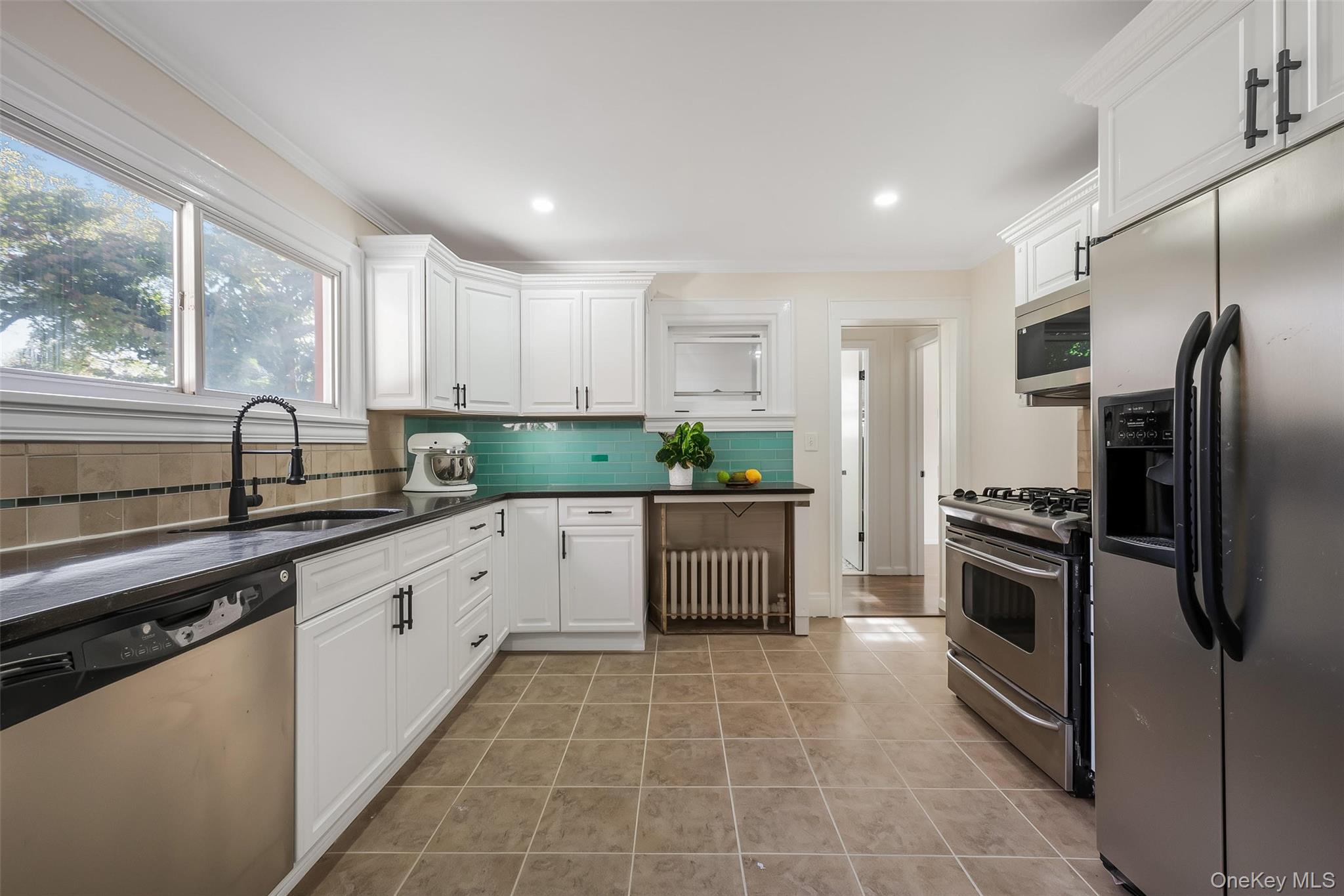 39 Hillcrest Road Hartsdale, NY 10530 - Photo 17 of 42 a kitchen with stainless steel appliances granite countertop a sink a stove a refrigerator and island with wooden floor
