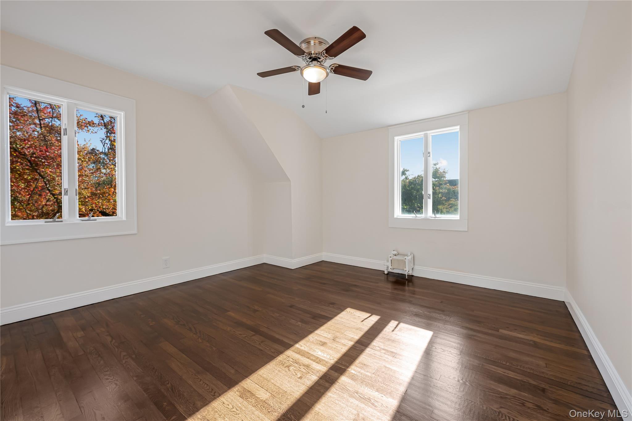 39 Hillcrest Road Hartsdale, NY 10530 - Photo 20 of 42 a view of an empty room with window and wooden floor