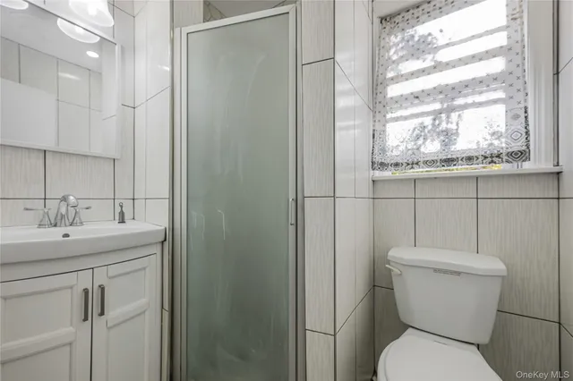 a white toilet sitting next to a bathroom sink