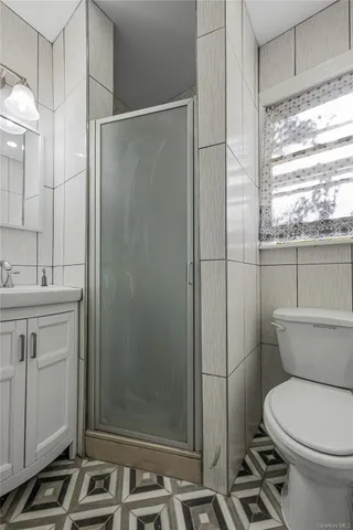 a bathroom with a toilet sink and shower