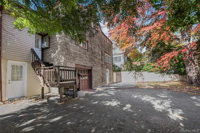 a backyard of a house with table and chairs