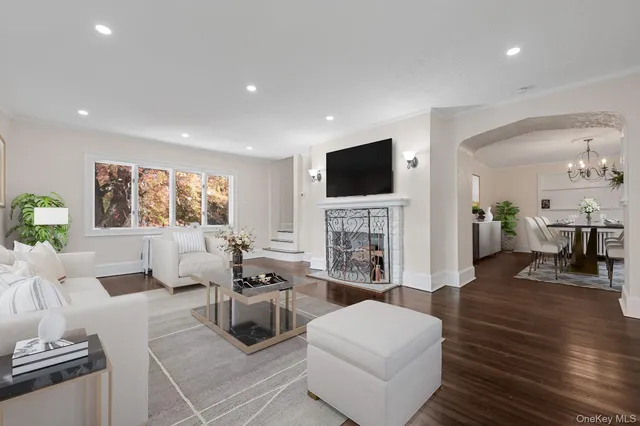 a living room with fireplace furniture and a flat screen tv
