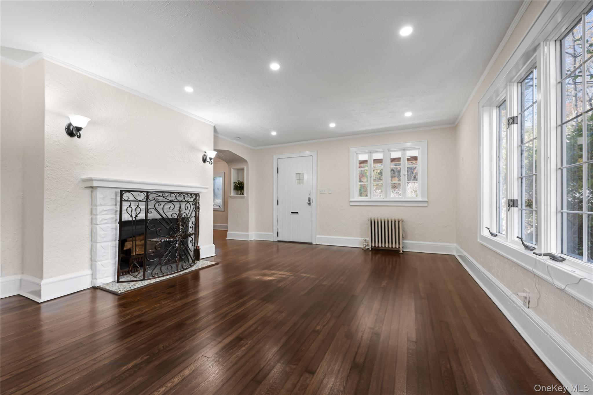 39 Hillcrest Road Hartsdale, NY 10530 - Photo 9 of 42 an empty room with wooden floor a fireplace and windows