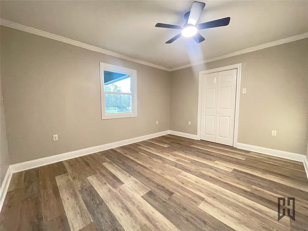 183 Beech Springs Road Minden, LA 71055 - Photo 14 of 28 a view of empty room with wooden floor and fan