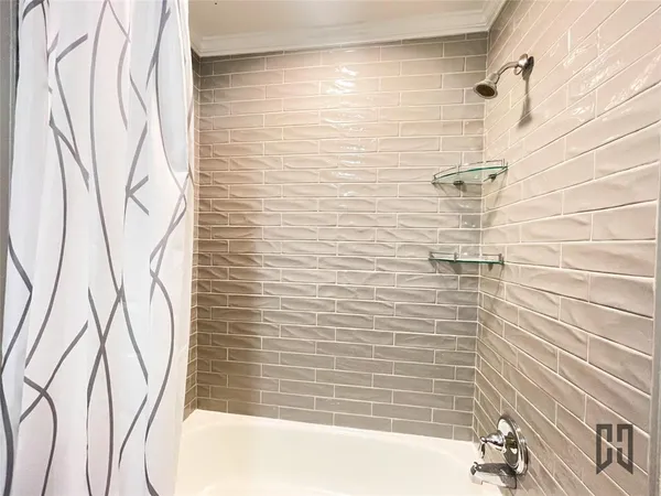 a bathroom with a bathtub and shower