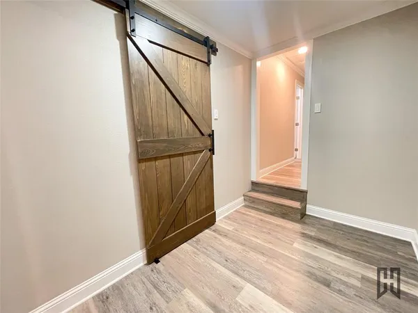 a view of entryway with wooden floor and stairs