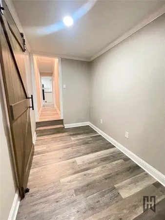 a view of a room with wooden floor and staircase