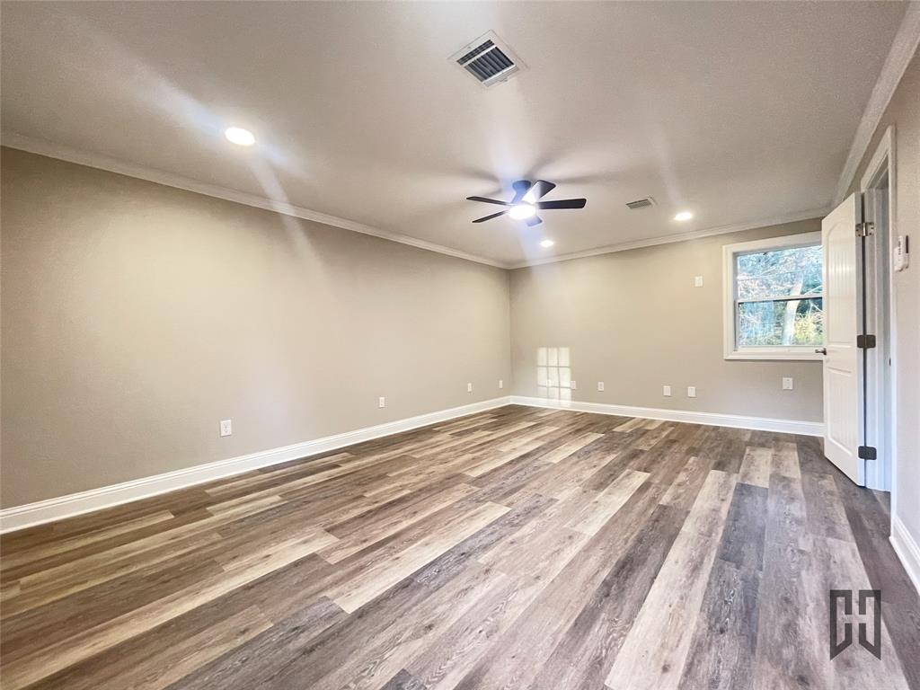 183 Beech Springs Road Minden, LA 71055 - Photo 22 of 28 wooden floor in an empty room with a window