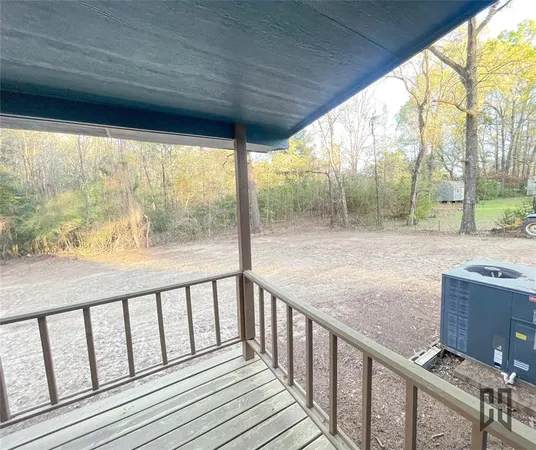 a view of roof deck with wooden floor and fence