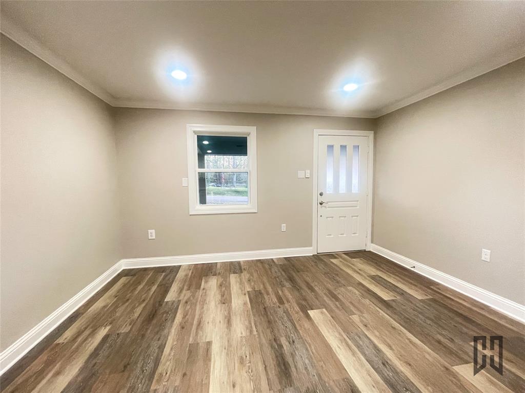 183 Beech Springs Road Minden, LA 71055 - Photo 9 of 28 a view of an empty room with wooden floor and a window