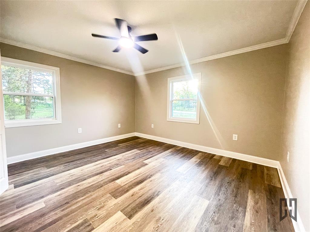 183 Beech Springs Road Minden, LA 71055 - Photo 10 of 28 a view of an empty room with wooden floor and a window