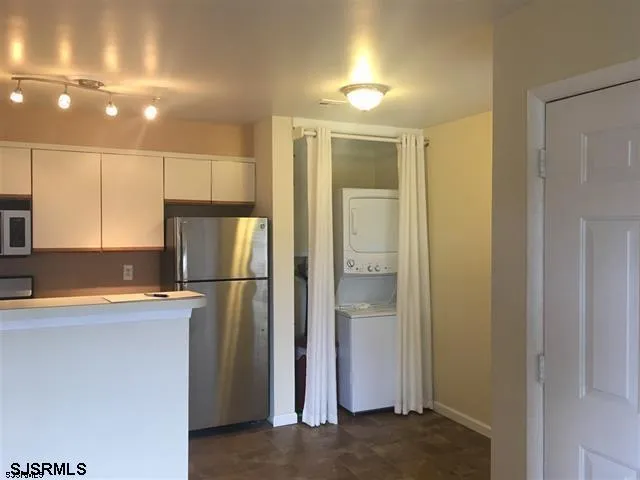 a kitchen with a refrigerator a sink and a stove top oven