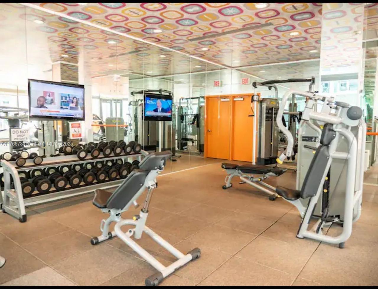 31 Southeast 6th Street, Unit 1601 Miami, FL 33131 - Photo 13 of 14 a view of a room with gym equipment