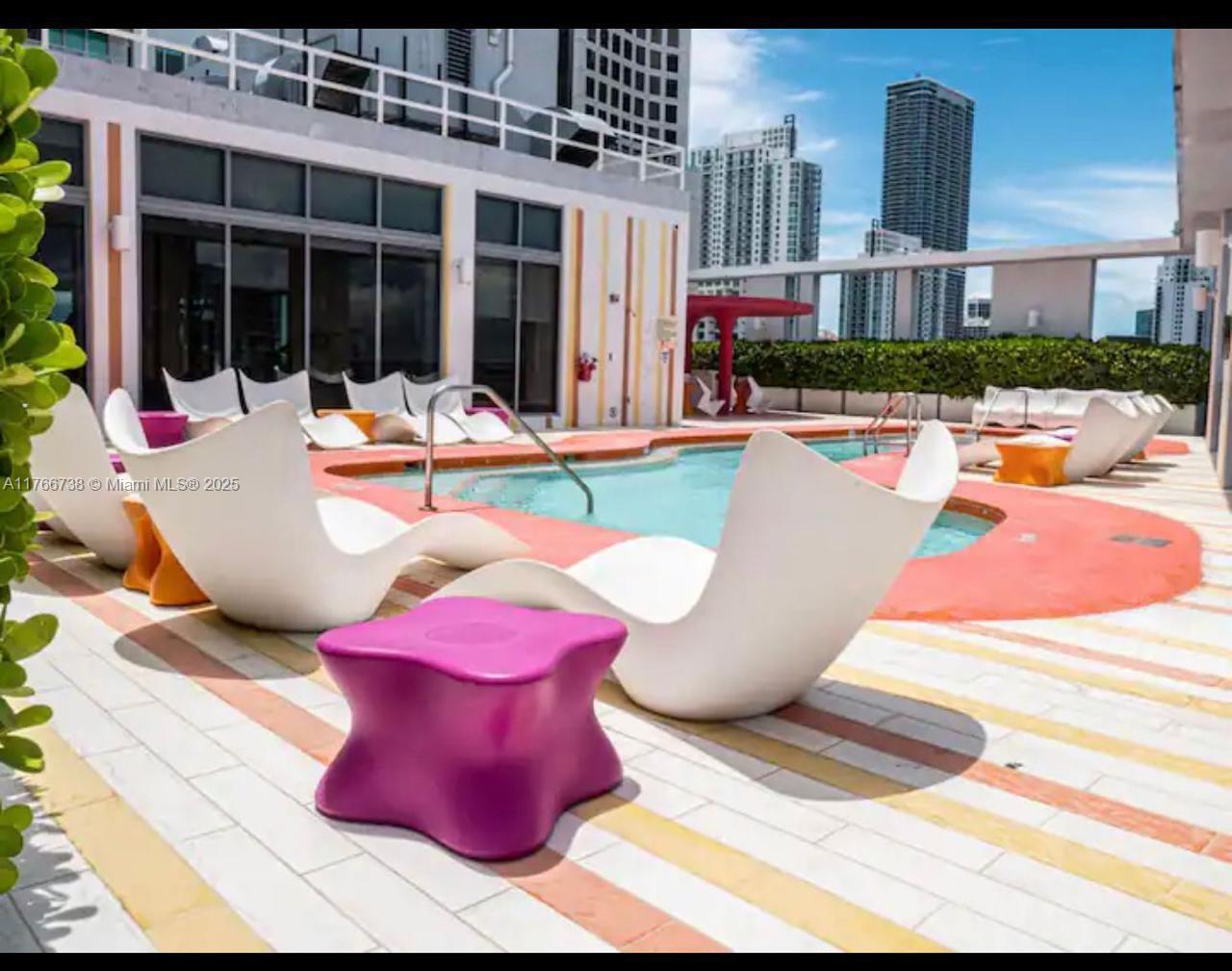 31 Southeast 6th Street, Unit 1601 Miami, FL 33131 - Photo 14 of 14 a view of a patio with couches chairs and potted plants