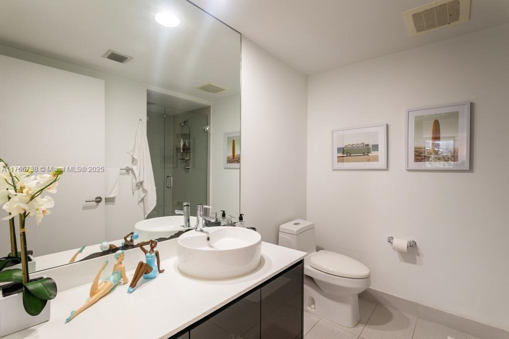 31 Southeast 6th Street, Unit 1601 Miami, FL 33131 - Photo 7 of 14 a bathroom with a sink and a mirror