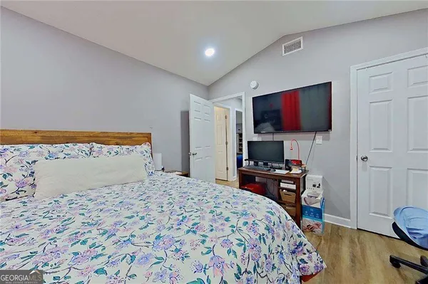 a bedroom with a bed and a flat screen tv