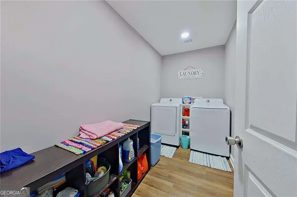 a children room with furniture and wooden floor