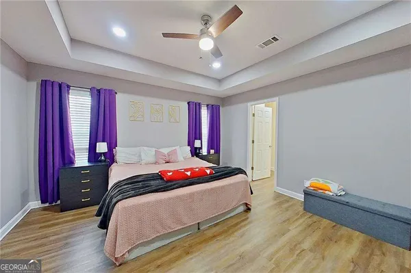 a bedroom with a bed and a chandelier