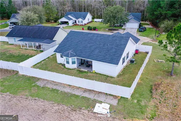an aerial view of house with a yard